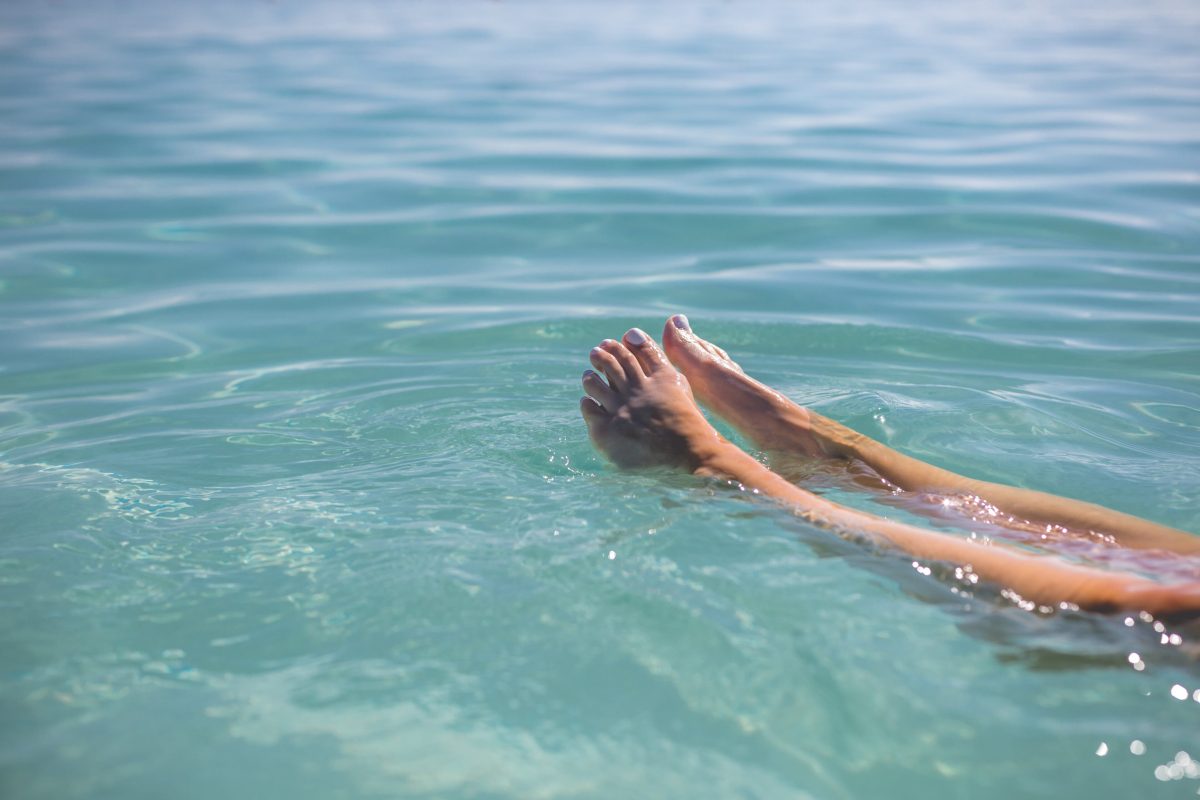 feet-floating-in-blue-water